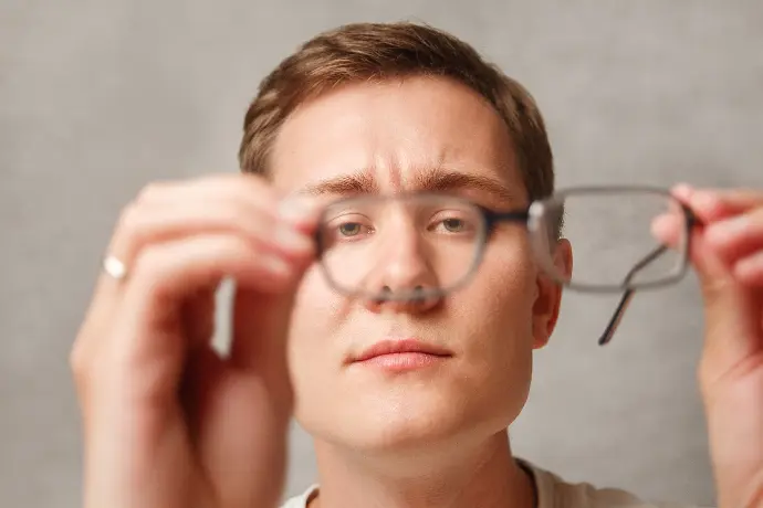 Glasses-GuyHoldingGlasses-Optical-Dispensing