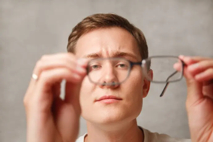 Glasses-GuyHoldingGlasses-Optical-Dispensing